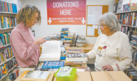 image of volunteers in the book sorting room