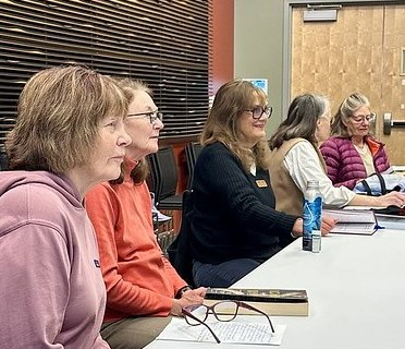image of book club participants sitting around a table