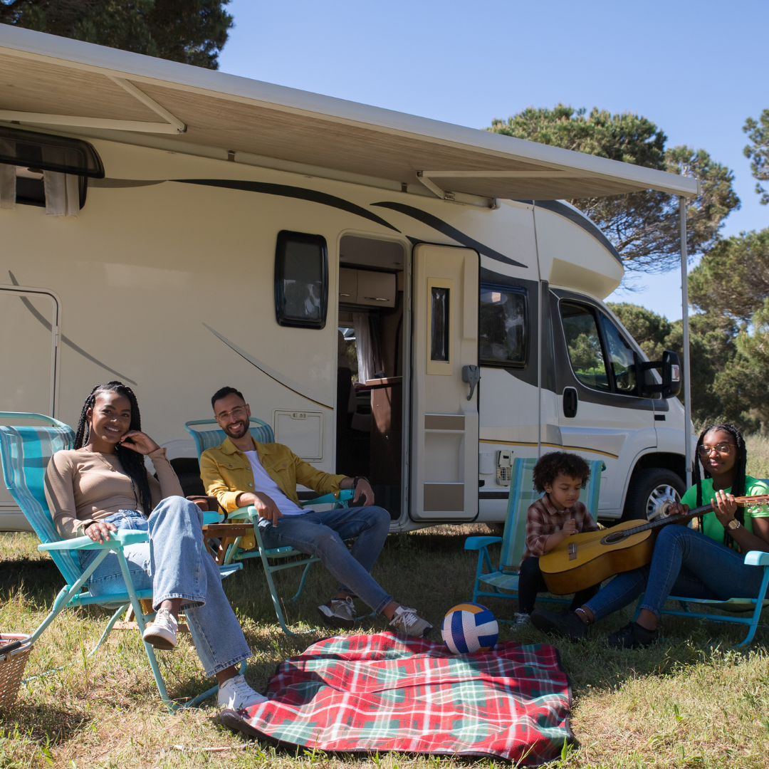 family picnicking outside their camper