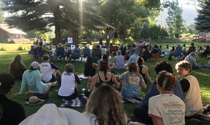 Large group of people sitting outside during a Story Slam